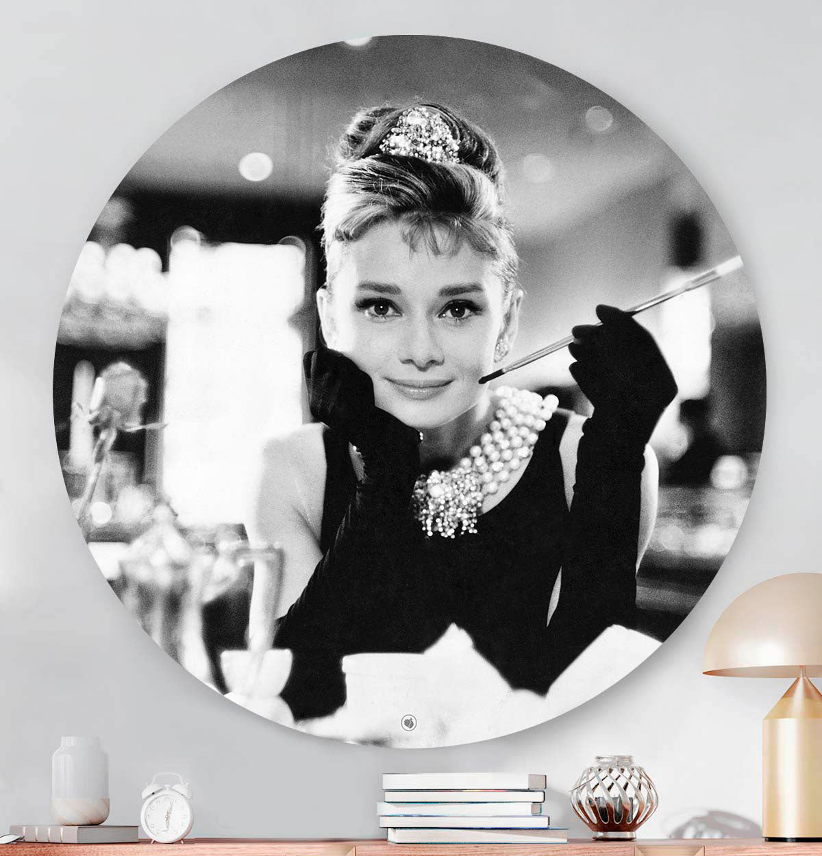 Muurcirkel die hangt aan de muur met Audrey Hepburn met een sigaret in haar hand aan het ontbijt.