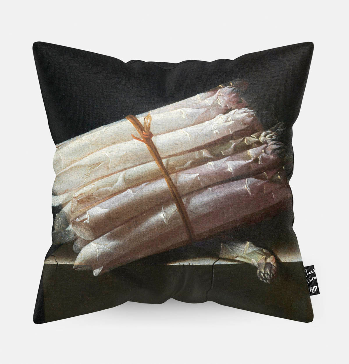 Kussen met schilderij van stilleven met asperges erop afgebeeld.