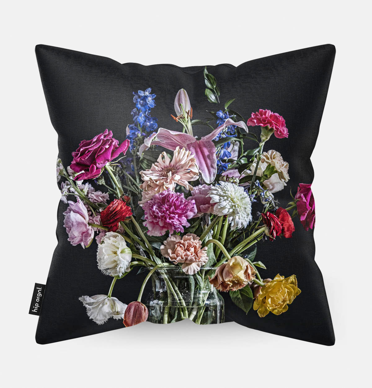 Achterzijde van een sierkussen met kleurrijke bloemen in een glazen vaas
