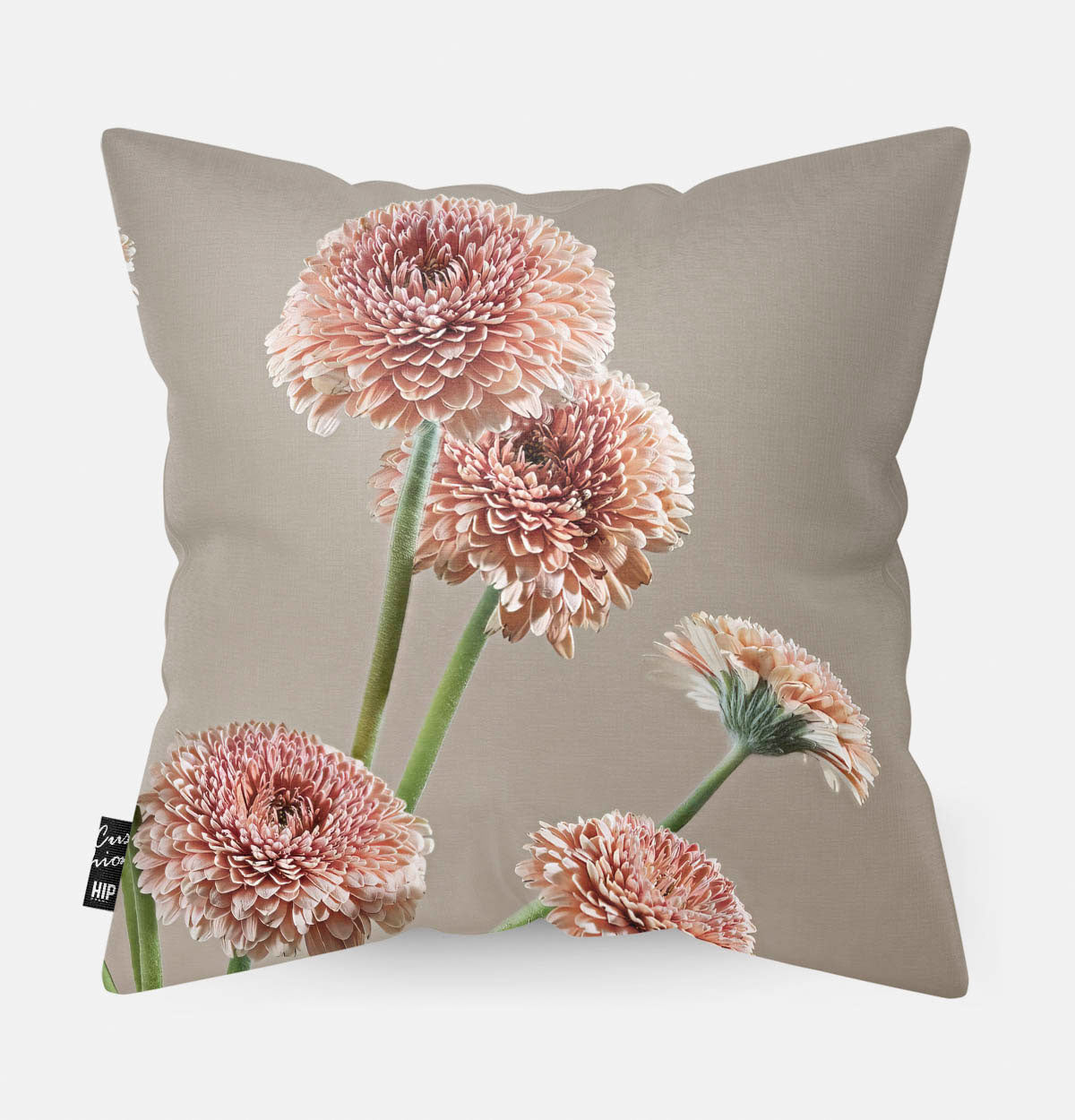 Achterzijde van een sierkussen met gerbera's en een beige kleur