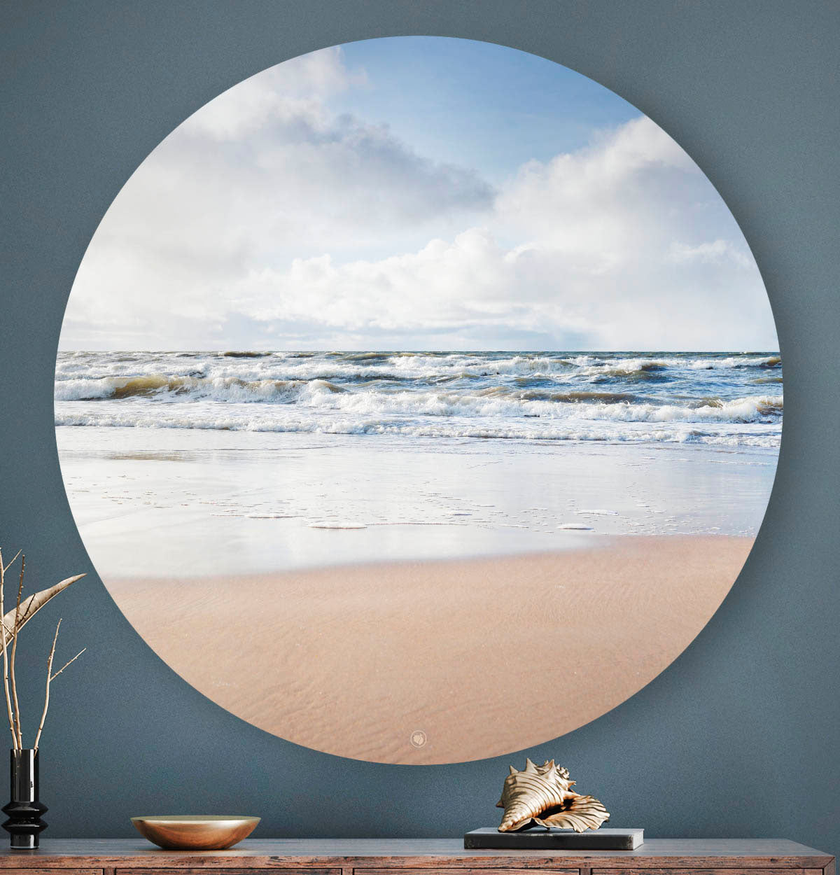 Wandcirkel met strand en zee tegen een blauwe muur
