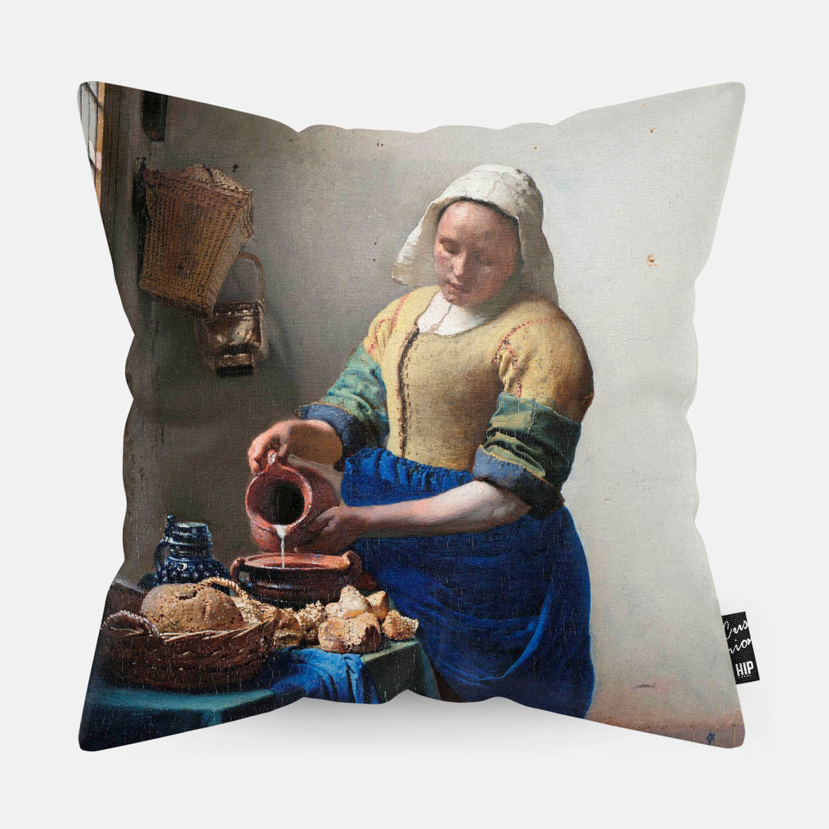 Kussen met schilderij van het melkmeisje erop afgebeeld.