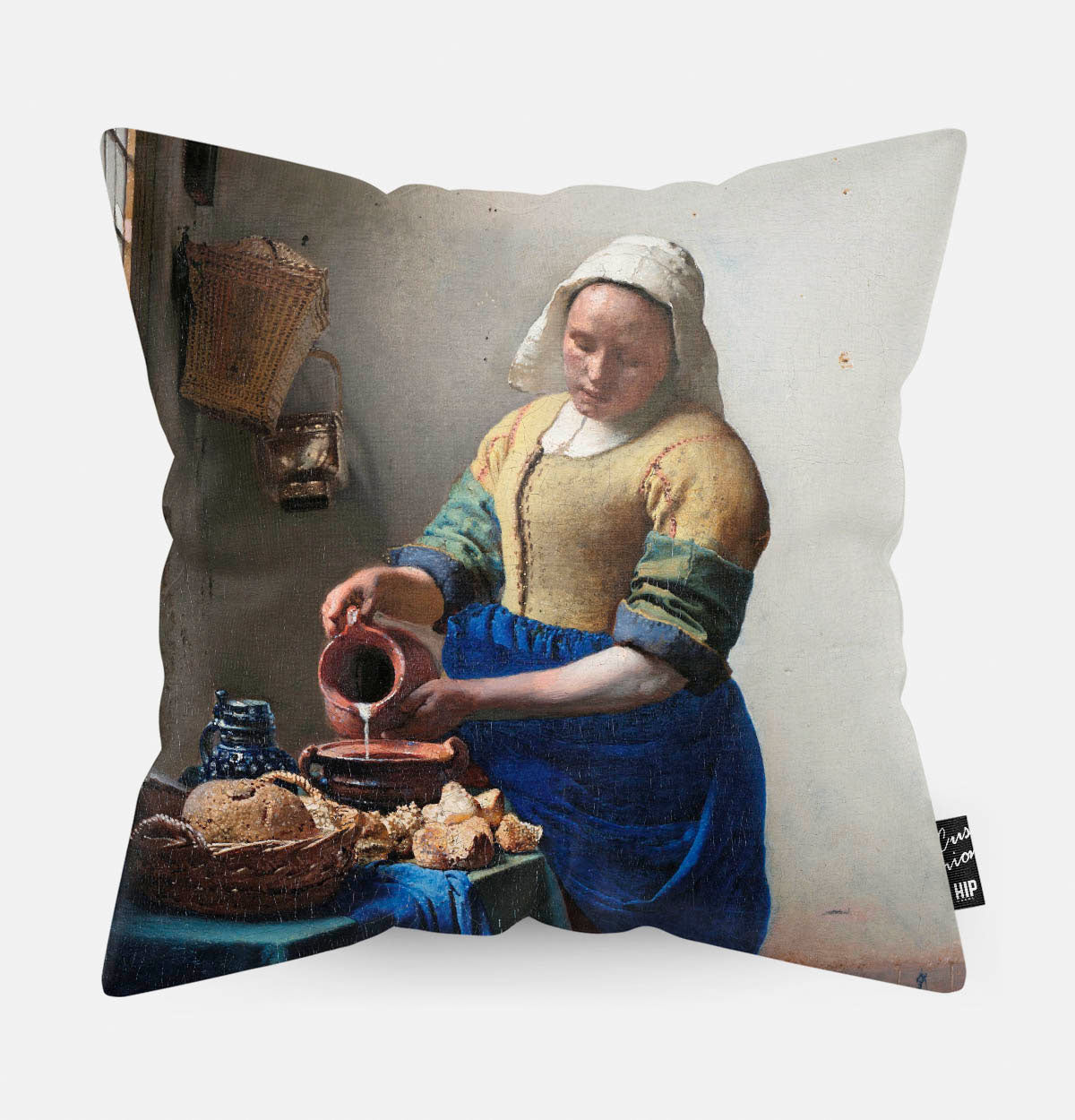 Kussen met schilderij van het melkmeisje erop afgebeeld.