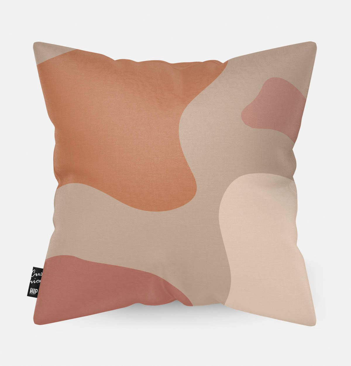 Kussen met line art met verschillende roze en oranje vierkanten erop afgebeeld.