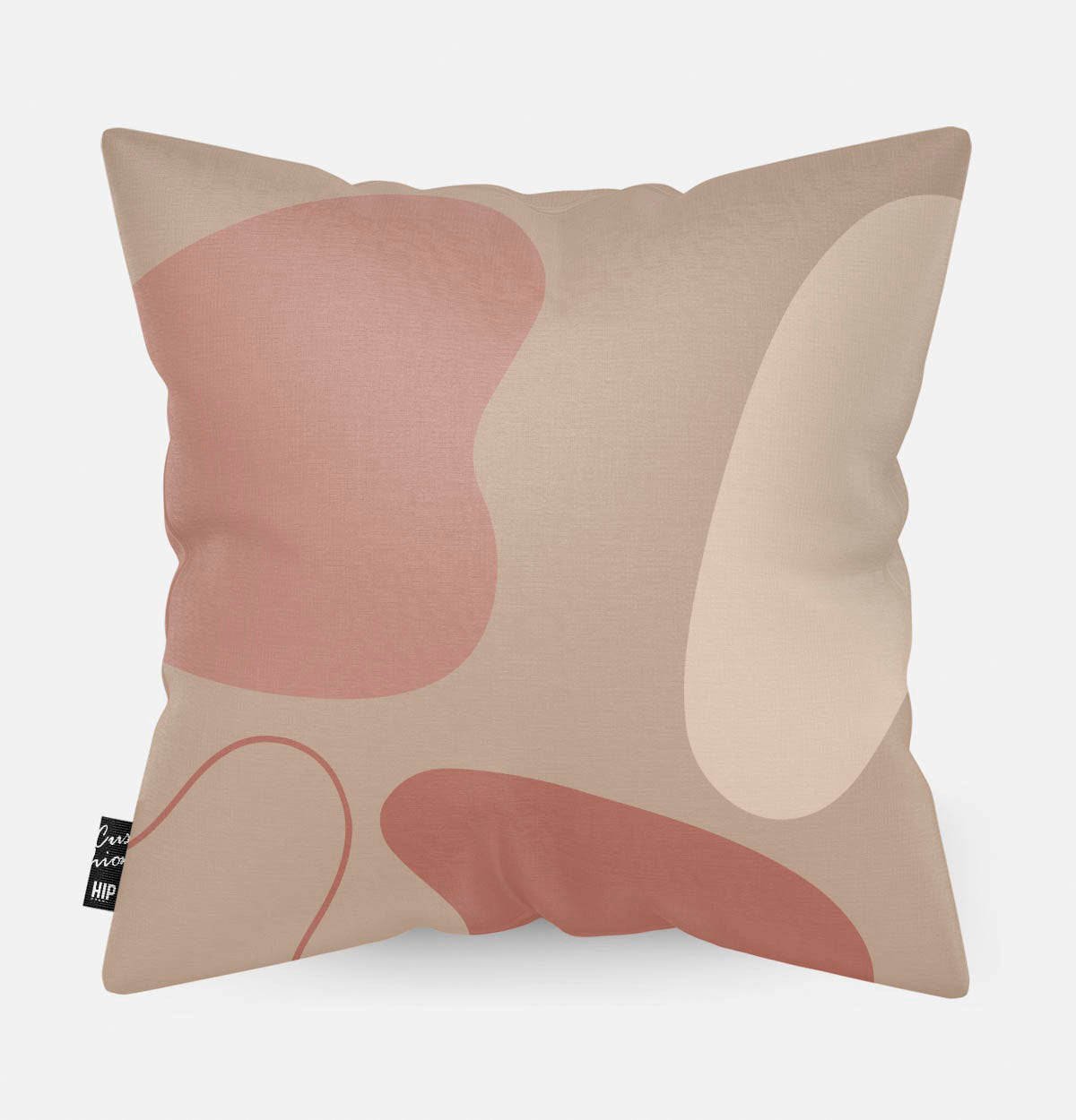 Kussen met line art met verschillende roze vierkanten erop afgebeeld.