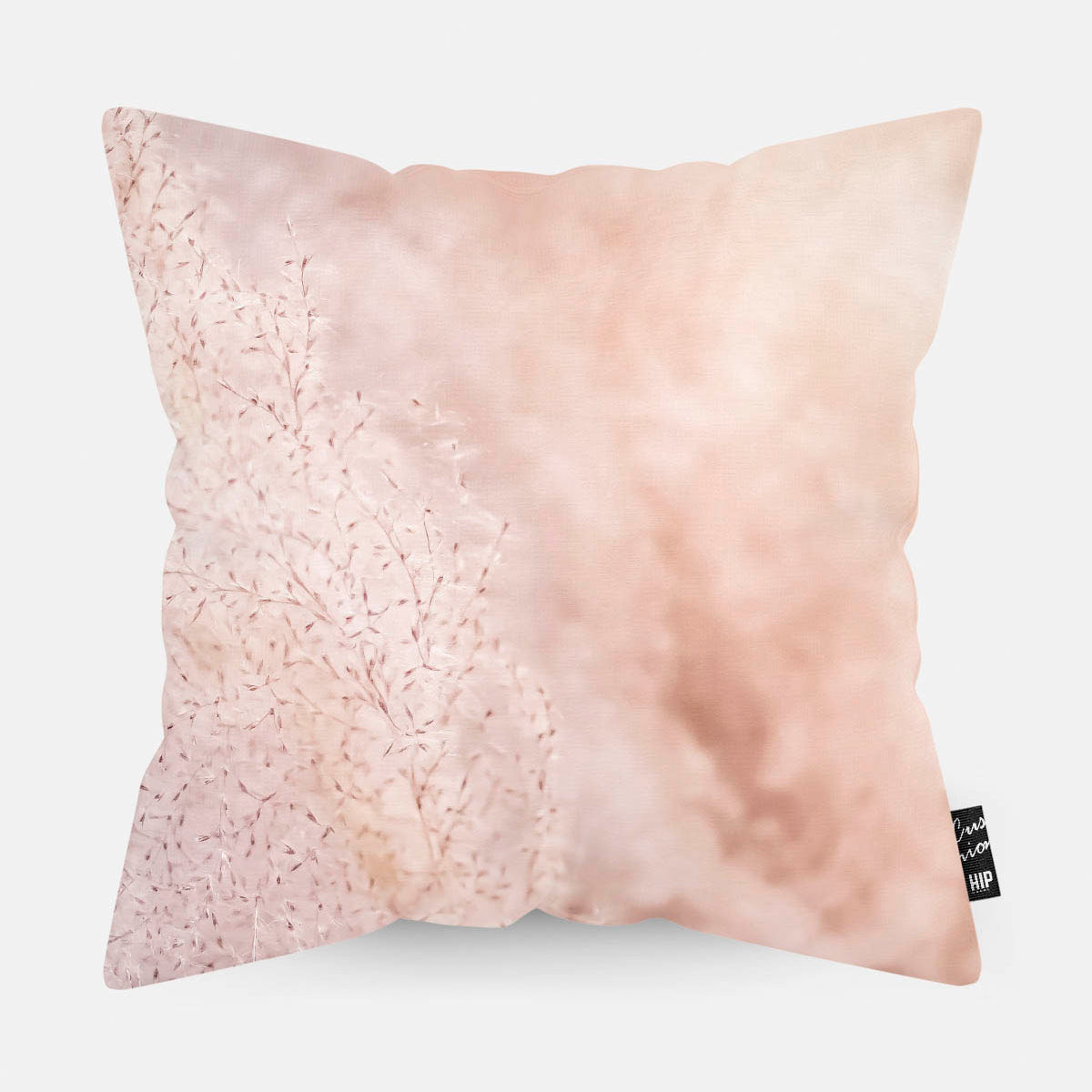 Kussen met roze pampas gras erop afgebeeld.