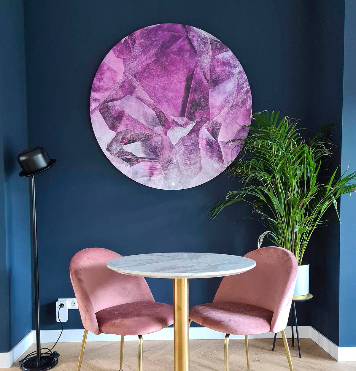 Woonkamer met wandcirkel met roze kristallen erop uitgebeeld.