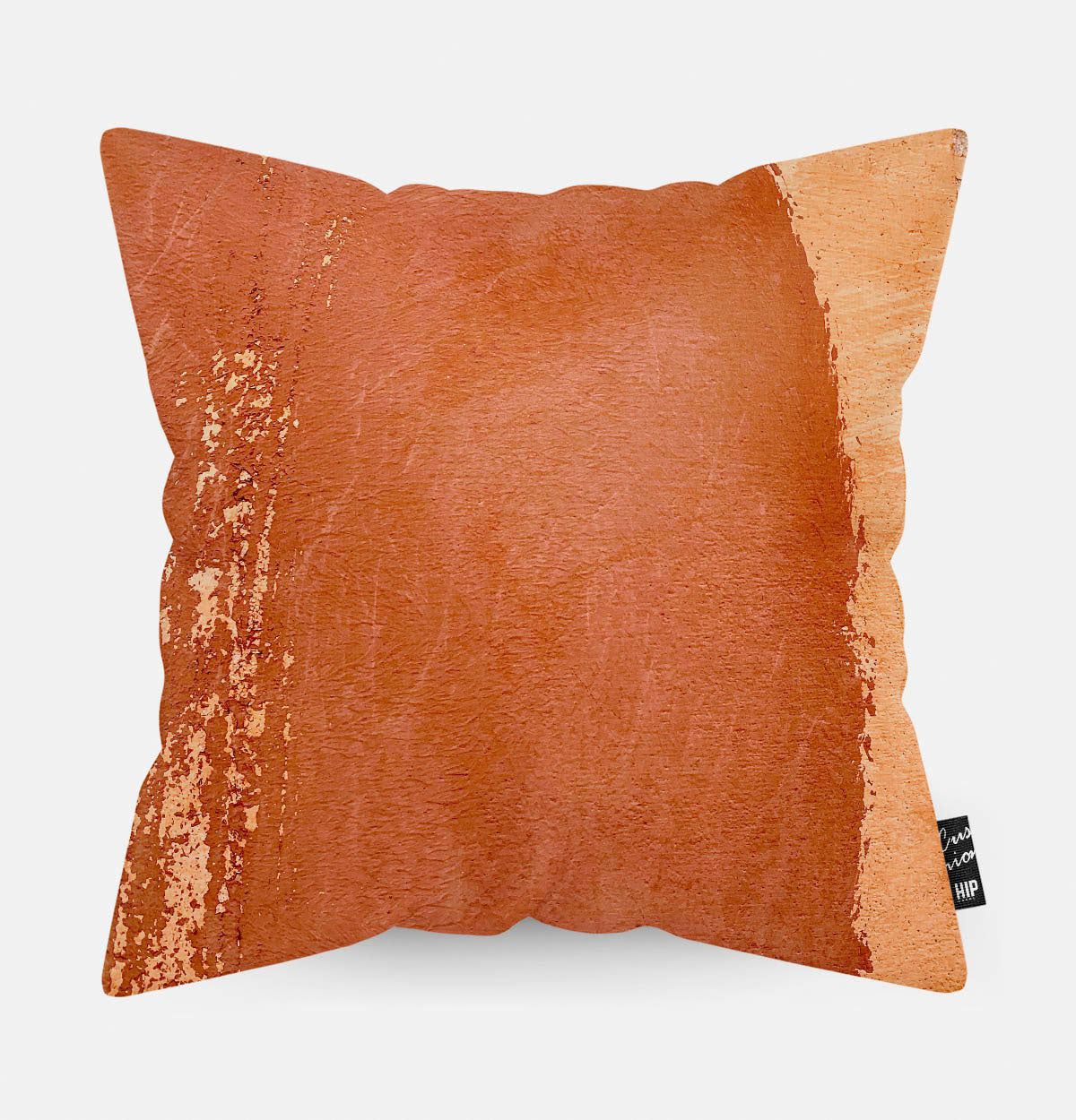 Kussen met terracotta steen erop afgebeeld.