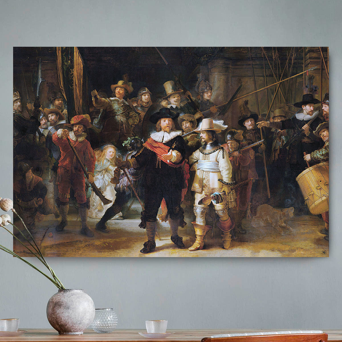 Vierkante wanddecoratie met schilderij van de Nachtwacht erop.