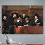 Vierkante wanddecoratie met schilderij van de staalmeesters erop.
