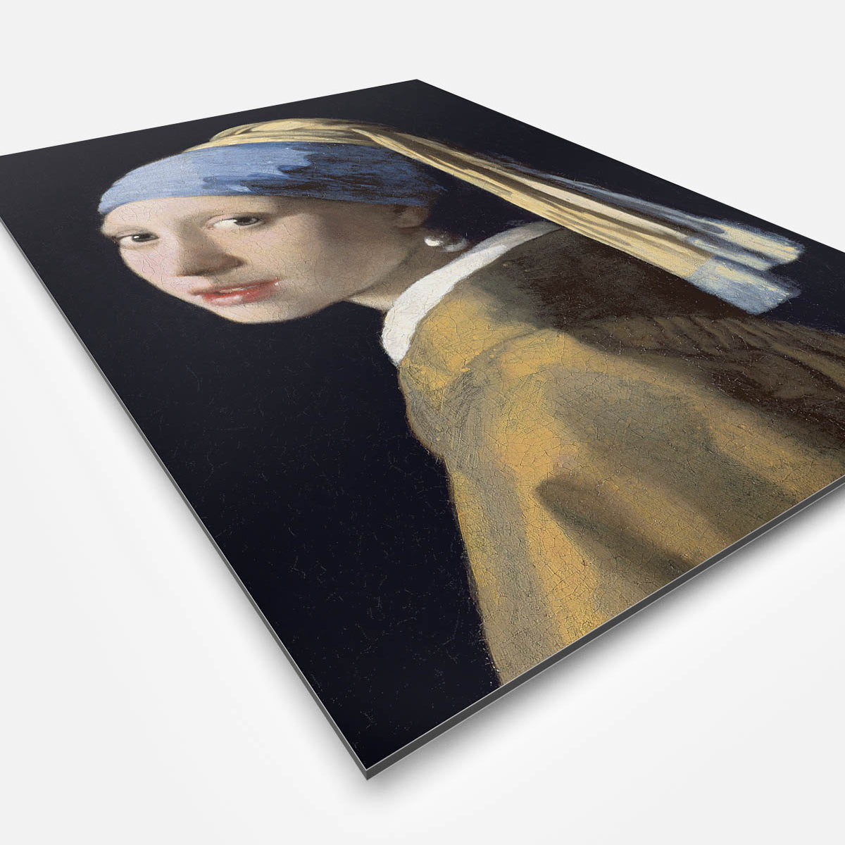 Vierkante wanddecoratie met schilderij van meisje met de parel erop.