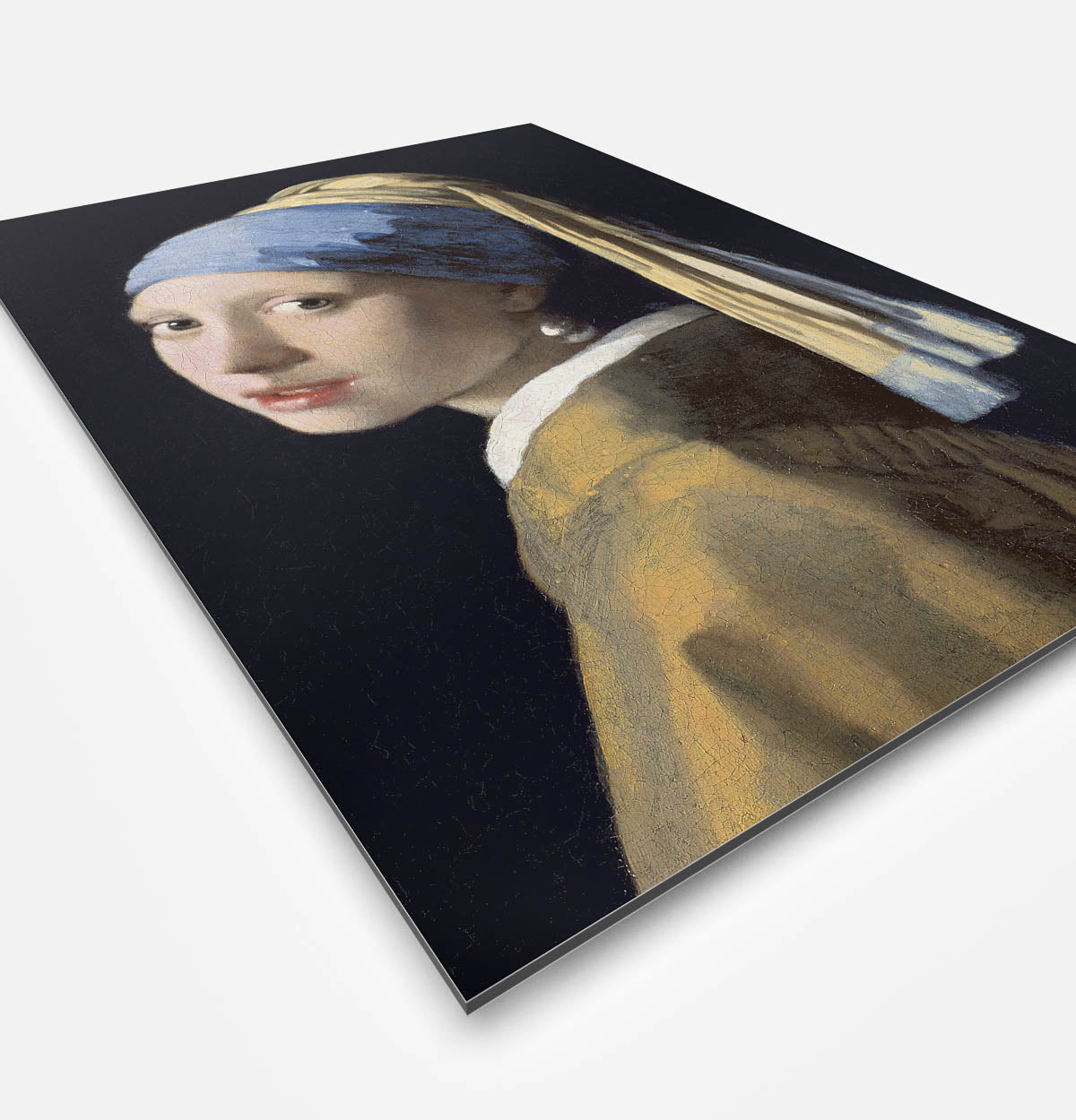 Vierkante wanddecoratie met schilderij van meisje met de parel erop.