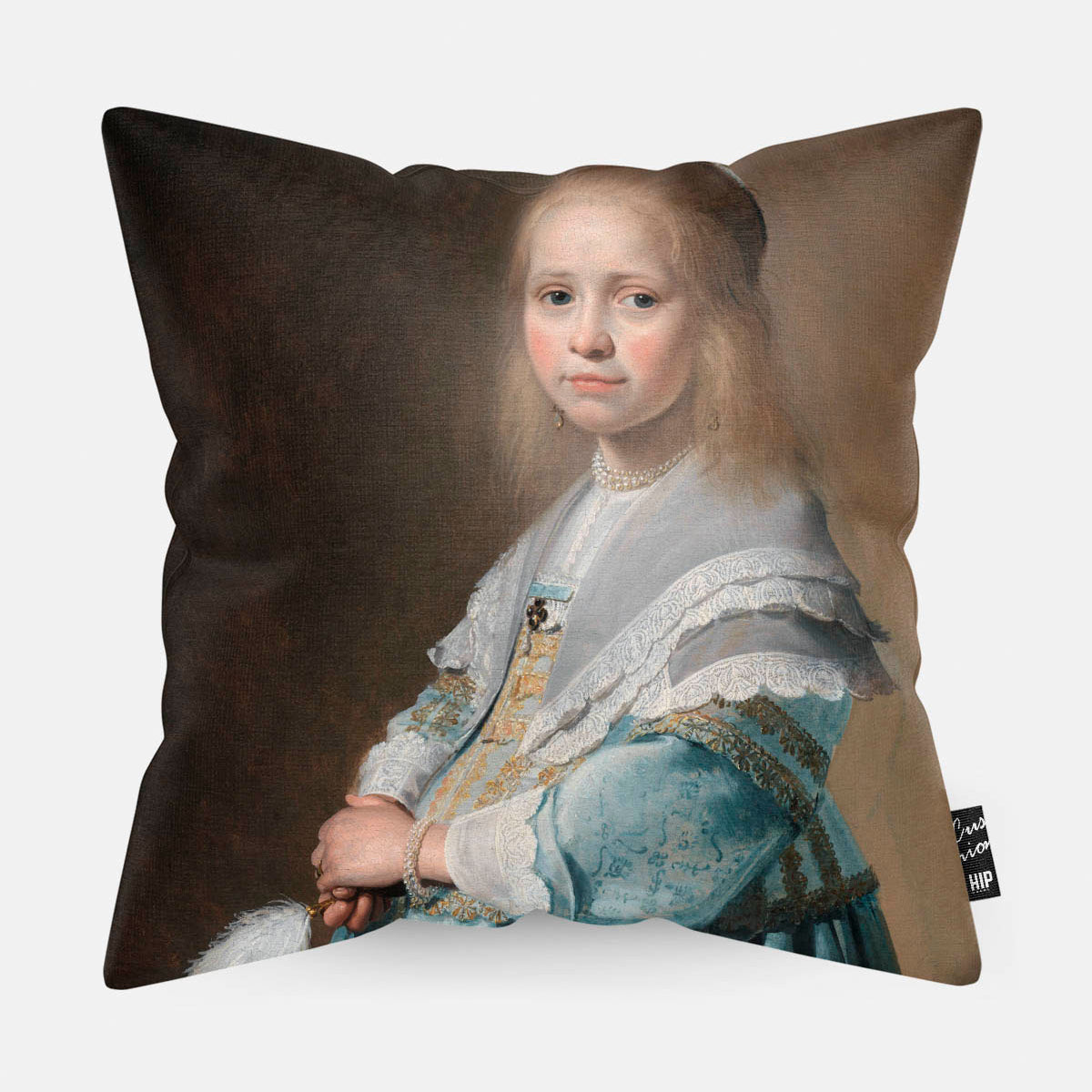 Kussen met schilderij van portret van een meisje in het blauw erop afgebeeld.